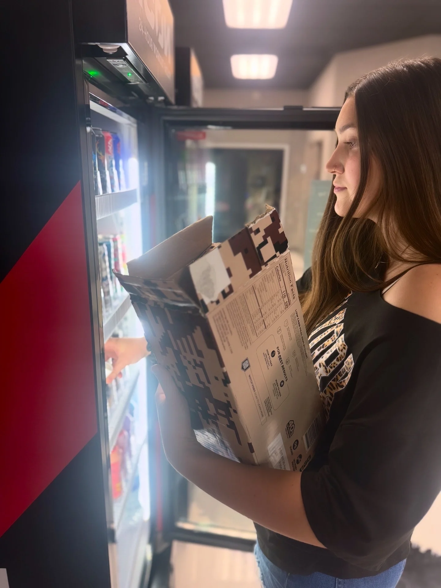 Woman choosing a drink from an open AI smart cooler